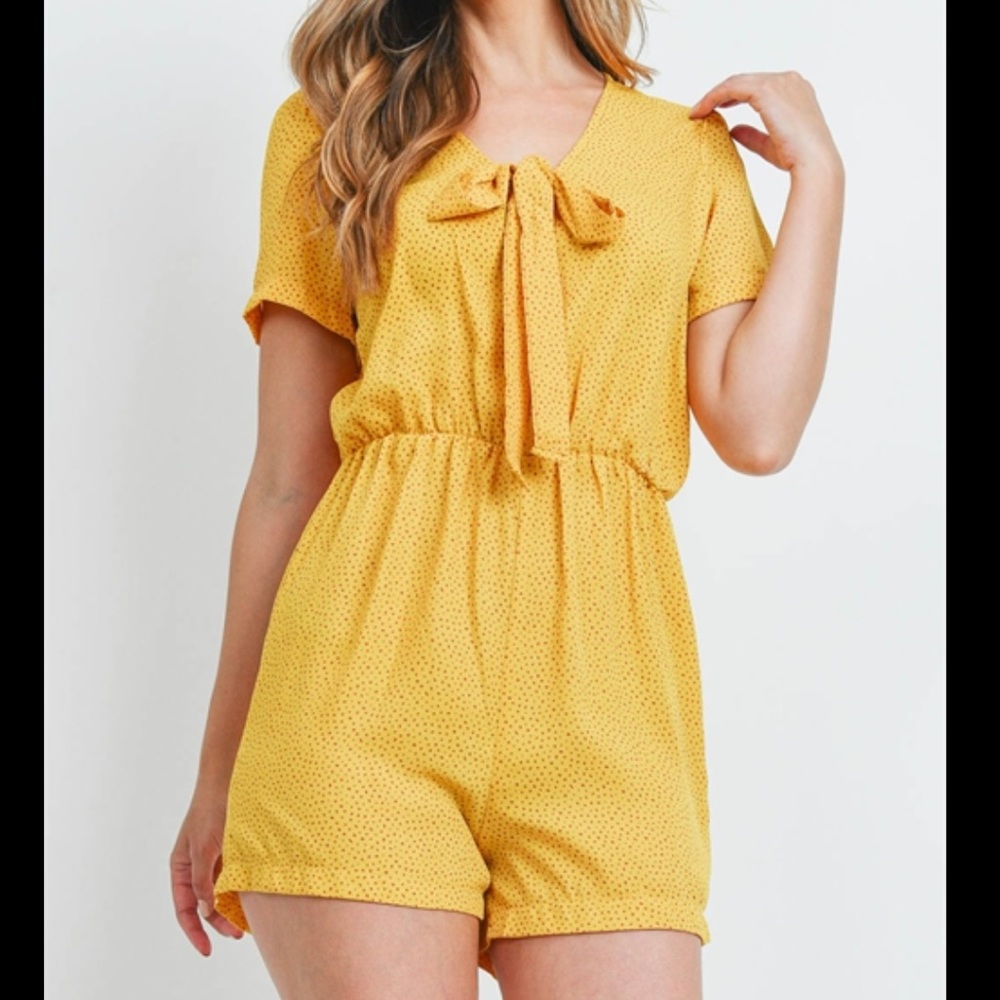 Cute gold romper with small red polka dots.